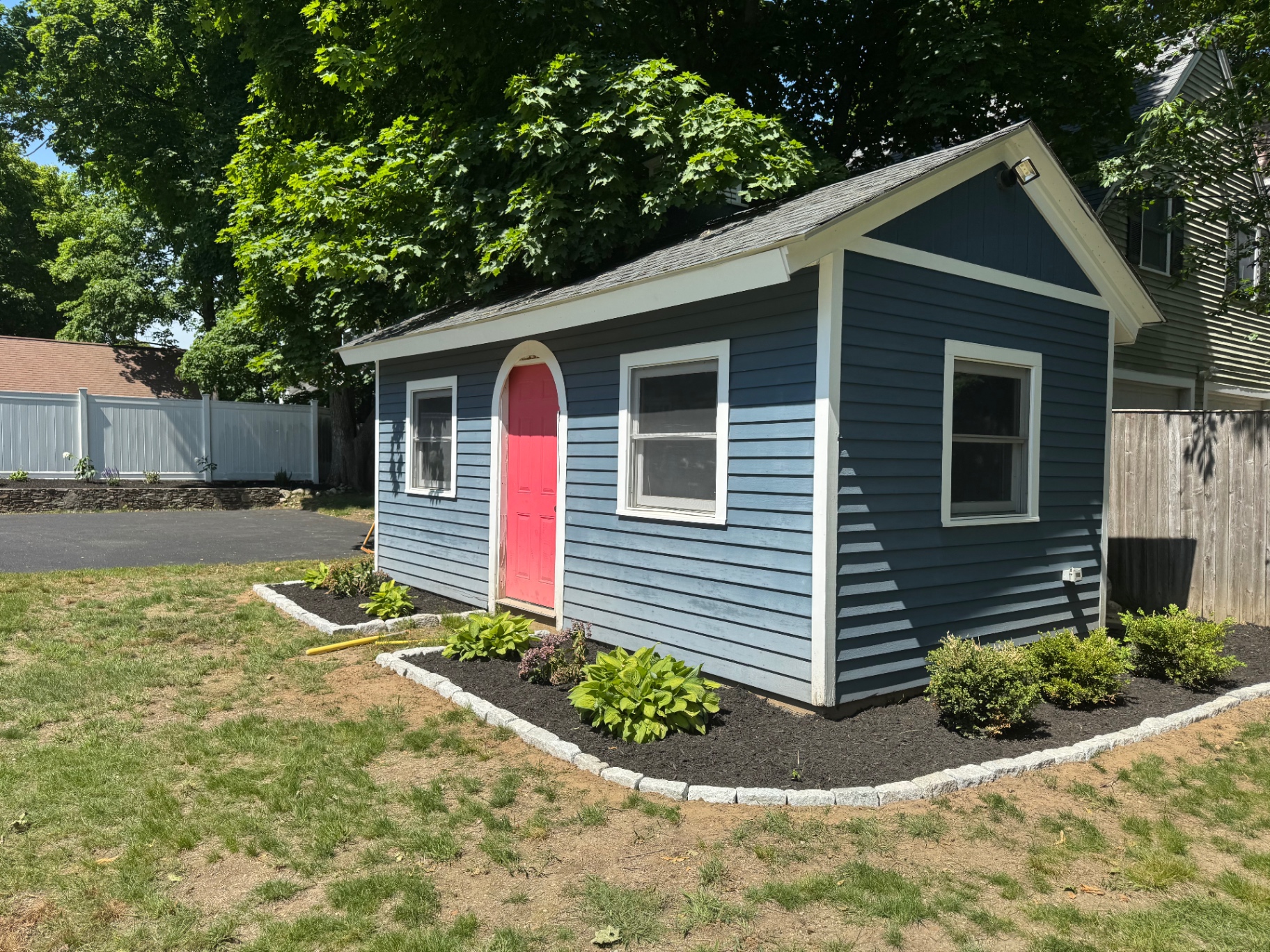 Fresh foundation bed planting around a backyard shed