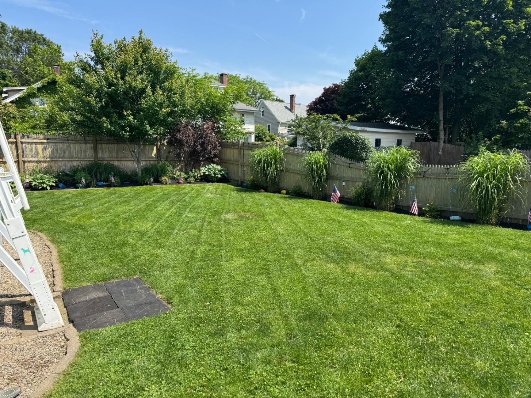 Large backyard lawn and border plantings in Dedham